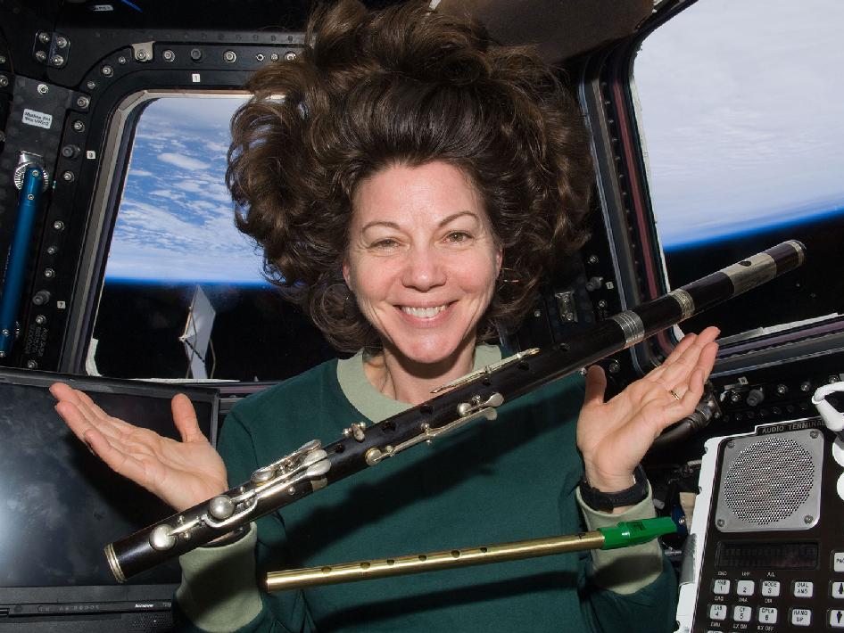 Astronaut Catherine Coleman with flutes in space
