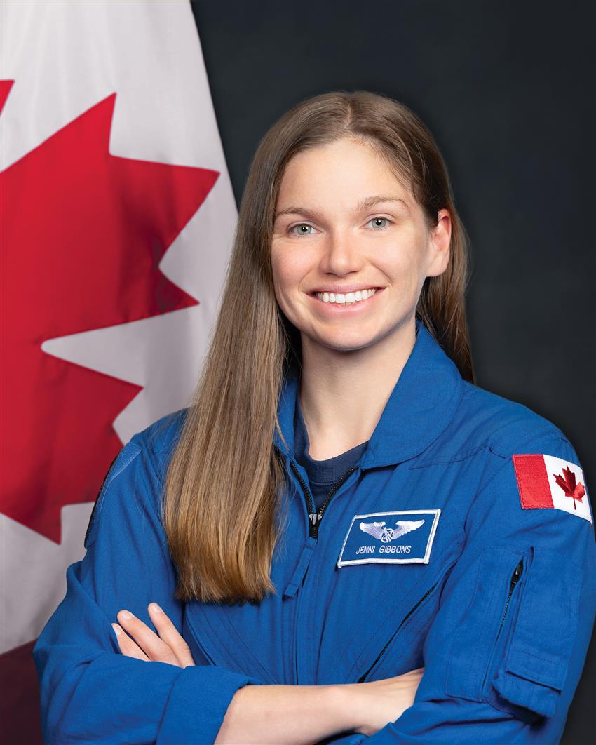 Close-up of Jenni Gibbons, she is wearing a blue flight suit