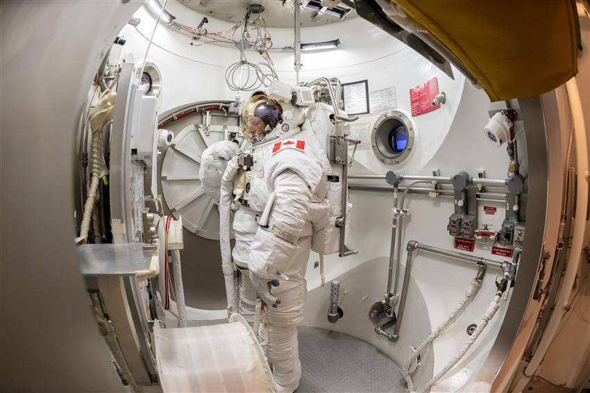 Joshua is wearing his spacesuit in a vacuum chamber.