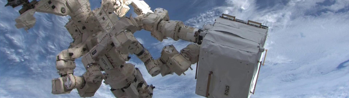 Dextre transfers materials from the HTV-2 cargo ship to the International Space Station