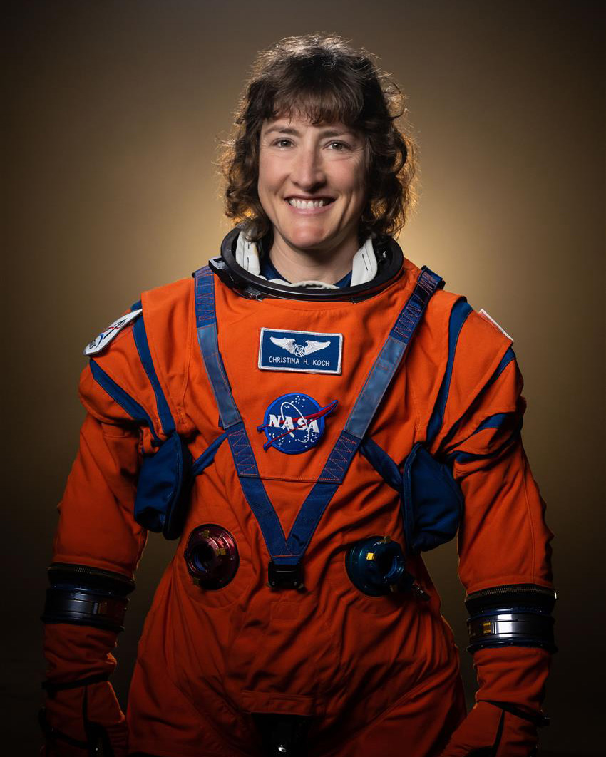NASA astronaut Christina Hammock Koch poses in her Artemis flight suit