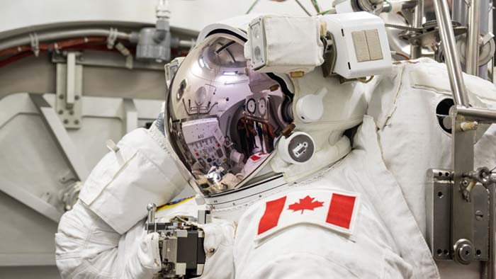 Joshua wears his spacesuit and helmet with the sun visor lowered