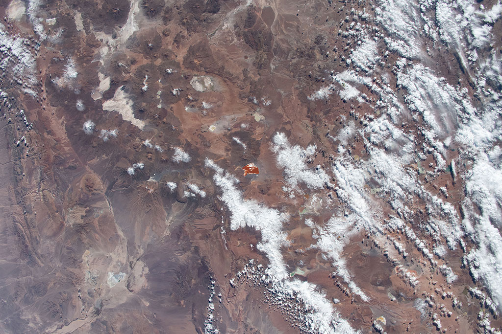 Laguna Colorada est un lac de sel peu profond en Bolivie, près de la frontière du Chili. Il est facilement repérable de l'espace grâce à sa teinte rouge, causée par des sédiments et la pigmentation de certaines algues. Le lac contient également des îles de borax, qui sont blanches et contrastent avec l'eau. Cette photo a été prise par David Saint-Jacques depuis la Station spatiale internationale. (Source : Agence spatiale canadienne/NASA.)