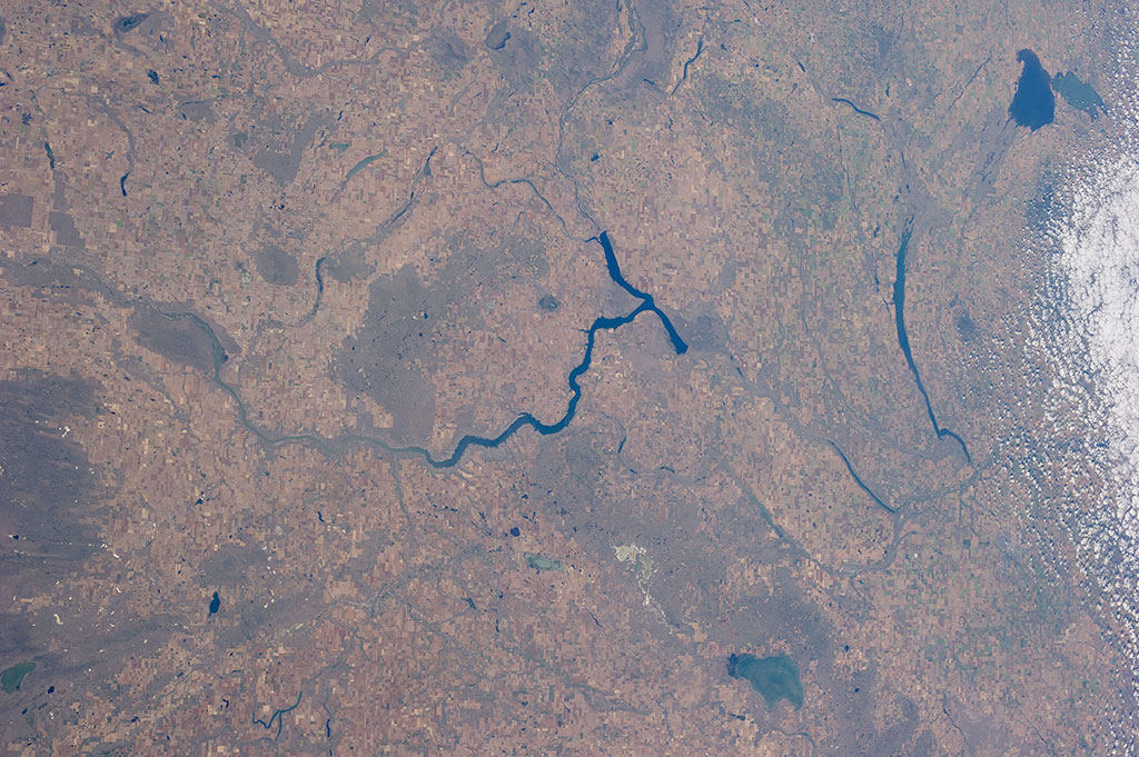 A habitat for Whooping Cranes to stopover in Saskatchewan. The Last Mountain Lake Migratory Bird Sanctuary is located in the right-center of the photo. (Credit: NASA)