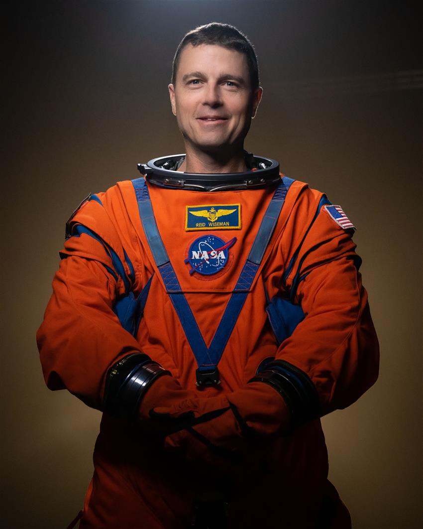 NASA astronaut Reid Wiseman poses in his Artemis flight suit
