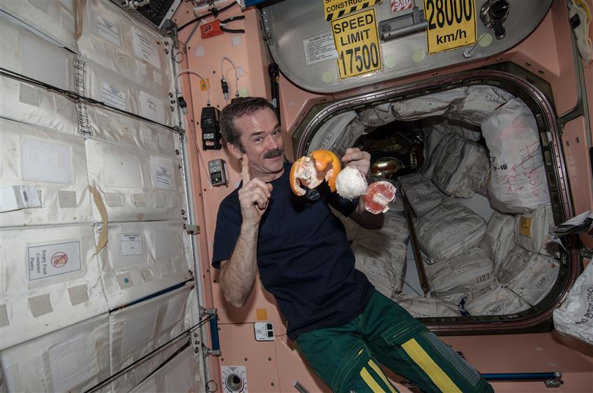 Chris Hadfield eating an orange in space