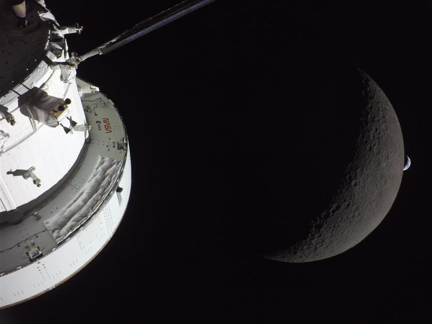 Orion in the foreground with Earth in the distance and the Moon between them. 