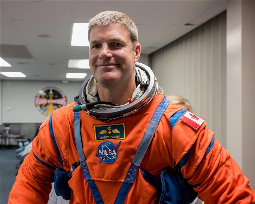An astronaut wears a spacesuit.