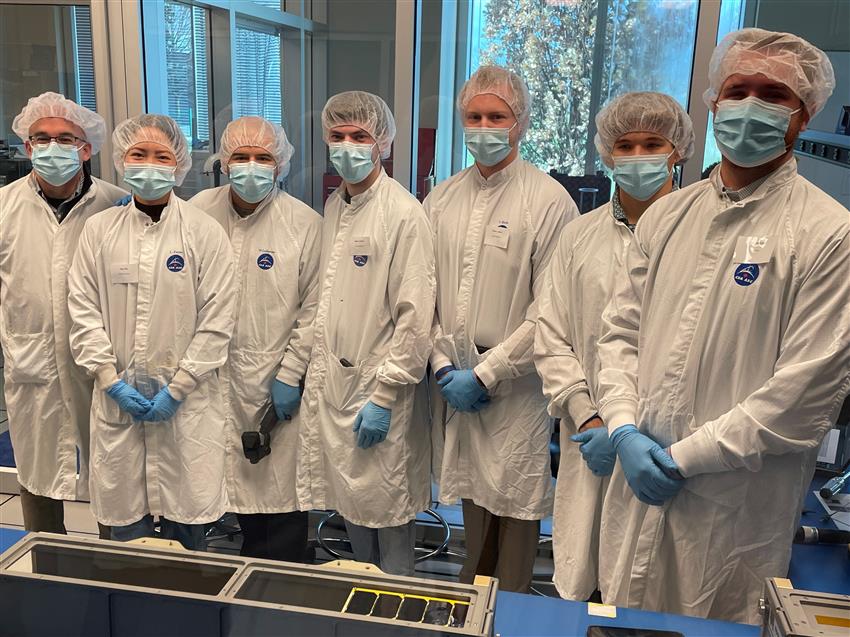 Team members from McMaster University in a clean room at the Canadian Space Agency
