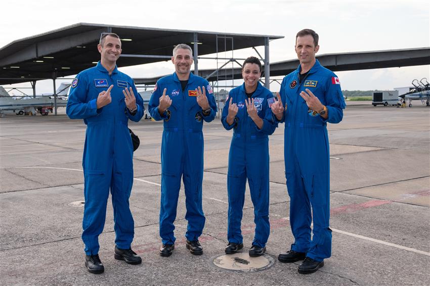 Sergey, Luke, Jessica, and Josh hold up fingers symbolizing the number 13. 