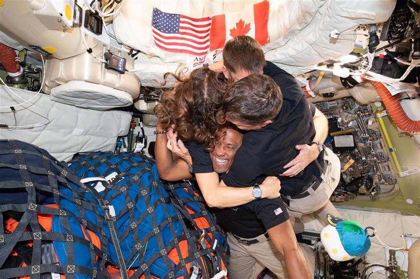 Christina, Jeremy, Reid and Victor hug inside the Orion spacecraft. 