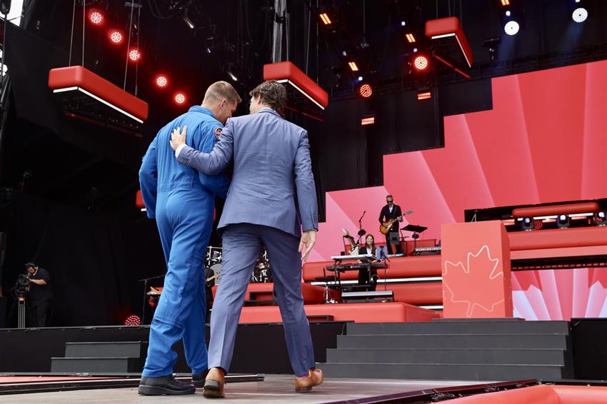 Jeremy Hansen and Prime Minister Justin Trudeau walking out of the stage on Canada Day 2023