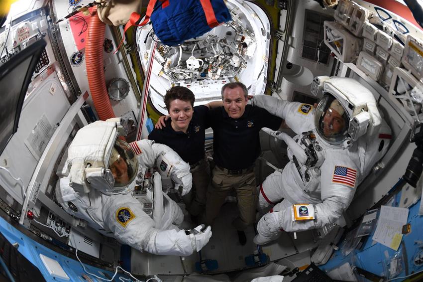 Les astronautes David Saint-Jacques et Anne McClain aident Christina Koch et Nick Hague à revêtir leur combinaison spatiale