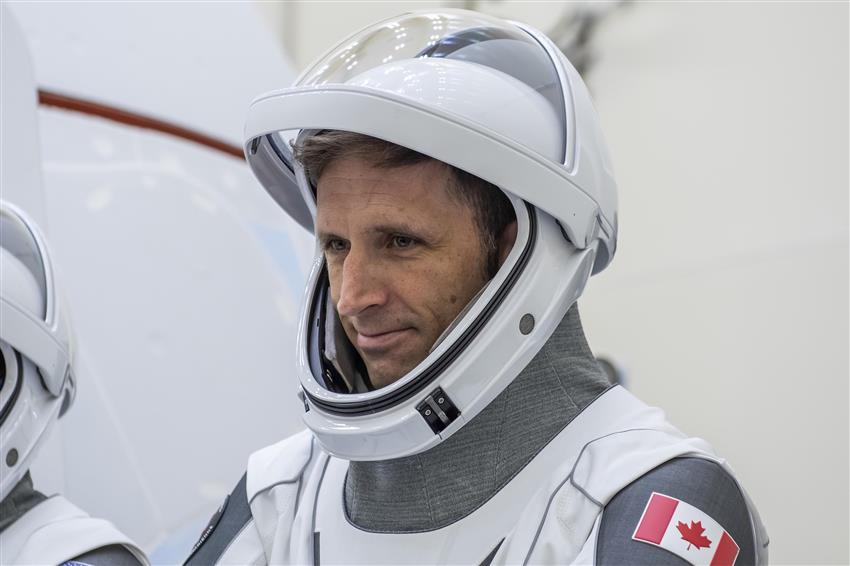 Joshua is pictured in a SpaceX space suit. 