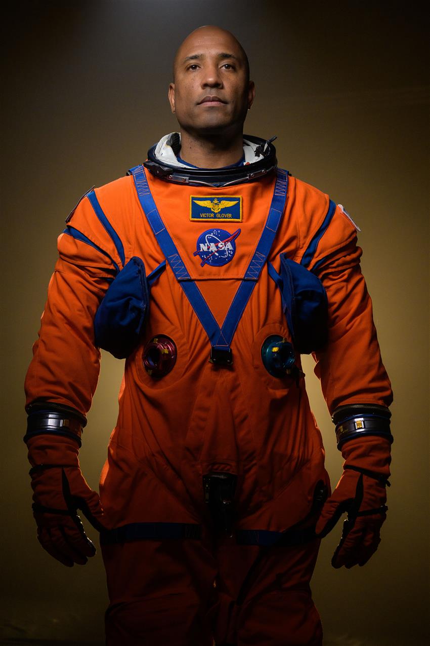 NASA astronaut Victor Glover poses in his Artemis flight suit