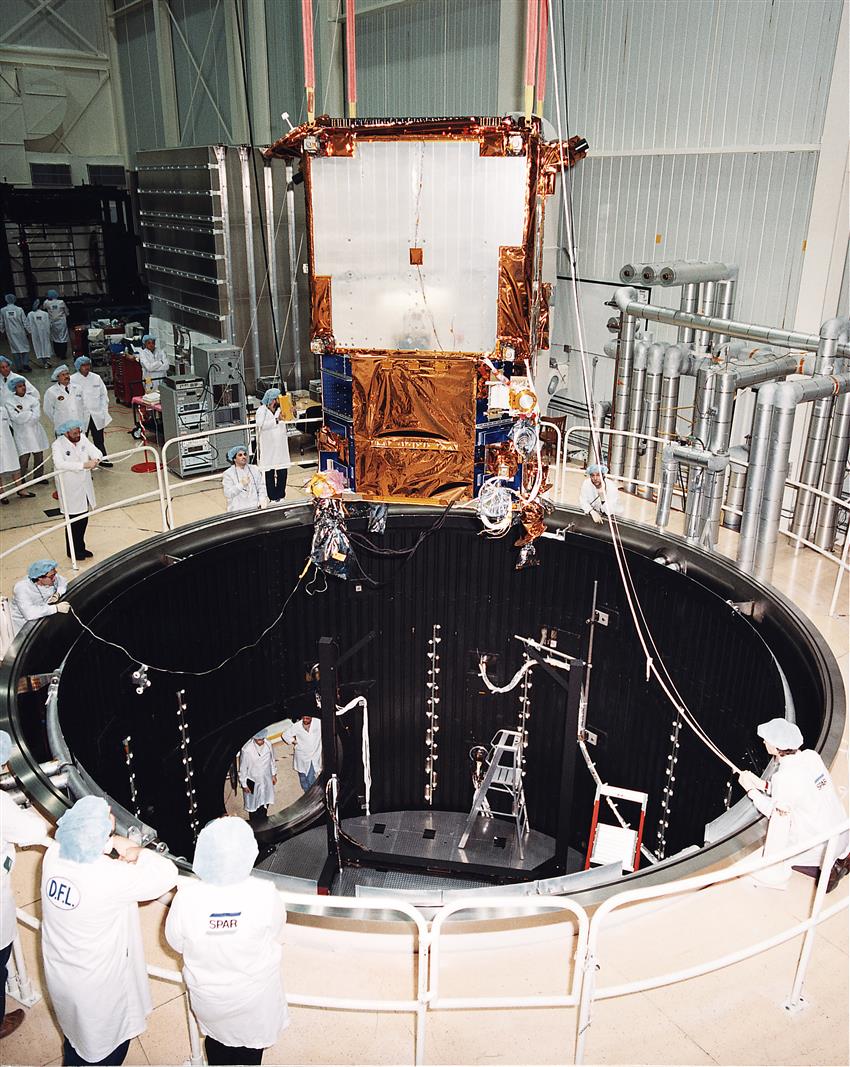 RADARSAT is bieng lowered into the Thermal Vacuum Chamber during thermal qualification