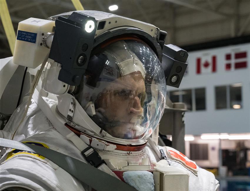 Gros plan de Joshua avec son casque d'astronaute, visière baissée.