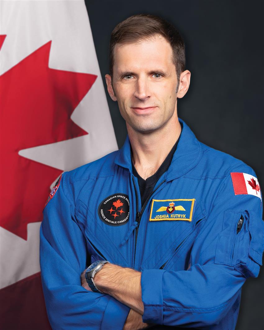 Close-up of Joshua, he is wearing a blue flight suit