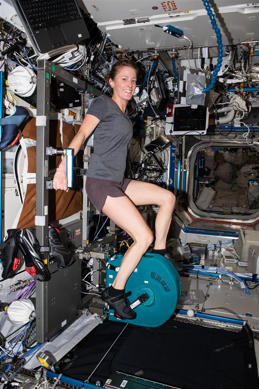 Loral pedals on the bike aboard the ISS