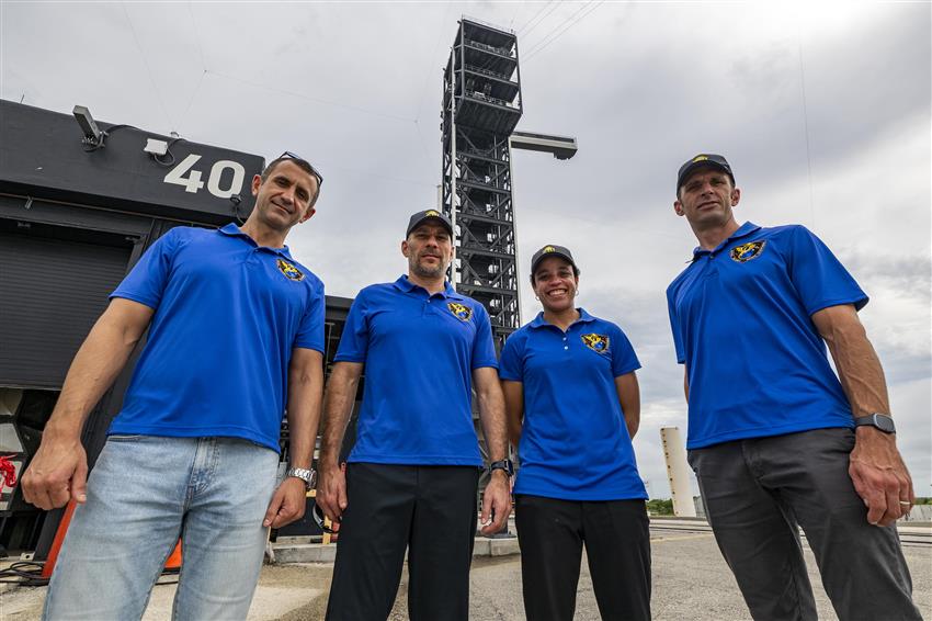 Sergey, Luke, Jessica, and Joshua stand in front of launch pad 40. 