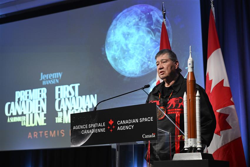 Bryan Akwirente Deer speaks at a podium.