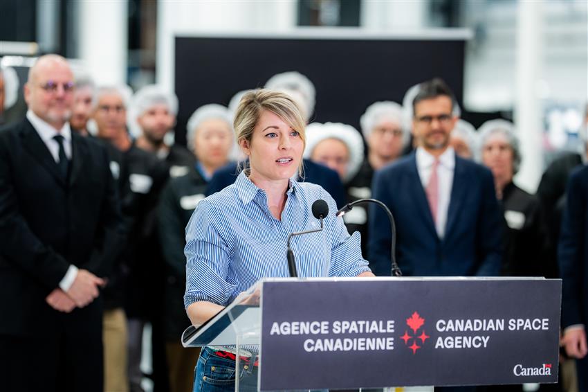 Minister Joly speaks at a podium.