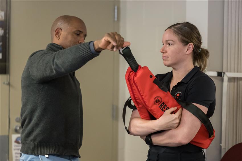 Jenni tests an inflatable belt with Victor Glover.