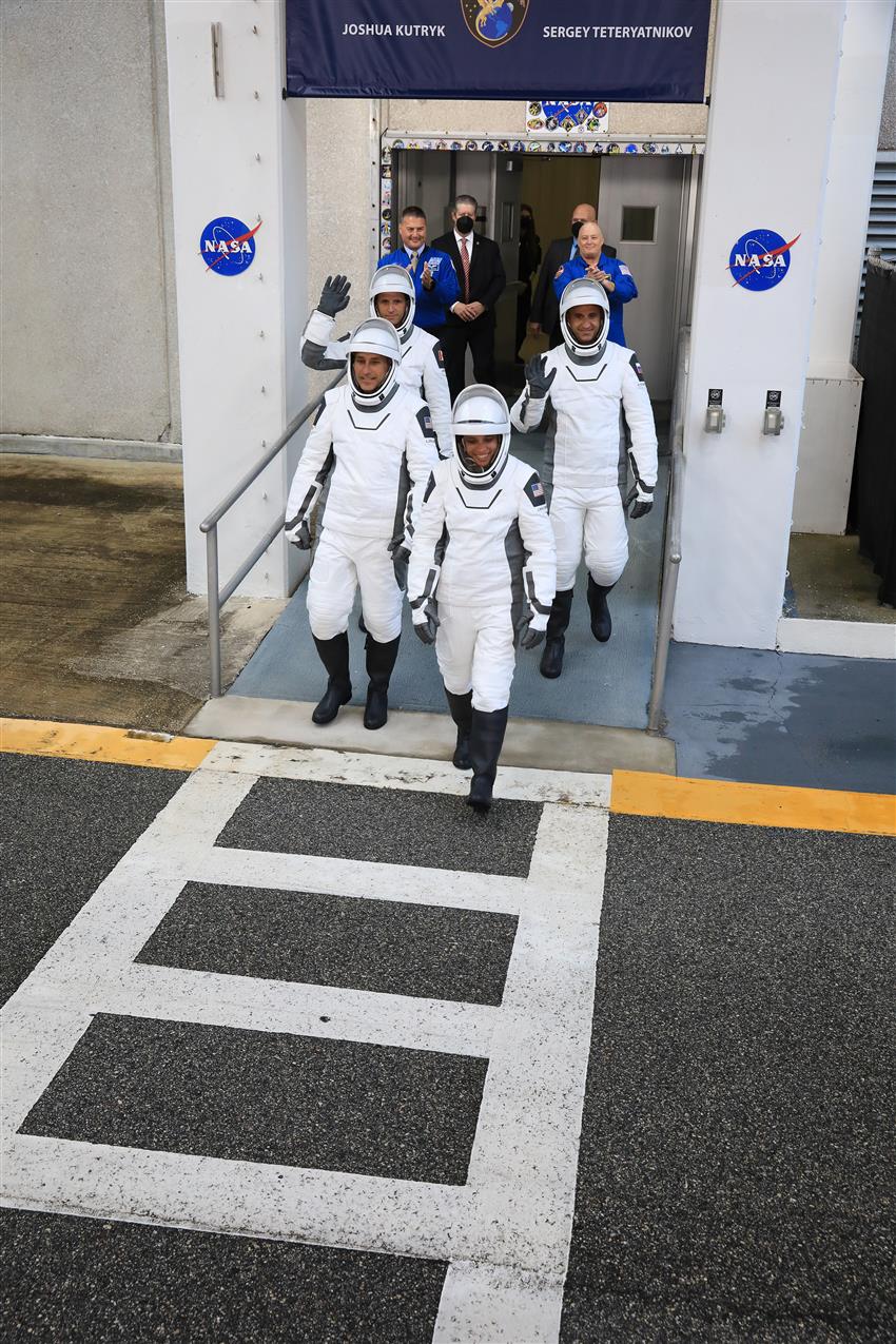 The astronauts are leaving the Space Center with NASA personnel.